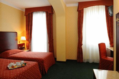 Postel nebo postele na pokoji v ubytování Hotel La Spia D'Italia