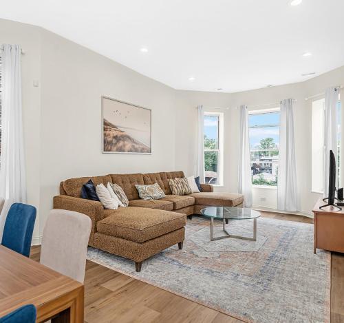 a living room with a couch and a table at Spacious 5-BR Apt next to transit Free Parking in Chicago