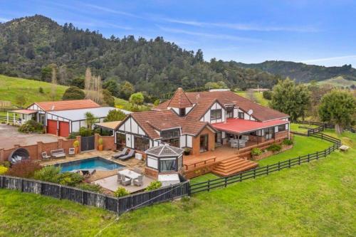 an aerial view of a large house with a pool at Chartré Manor B&B in Thames