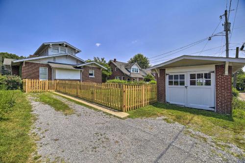 a fence in front of a house with a garage at Bristol Bungalow Less Than 1 Mi to Country Music Museum in Bristol