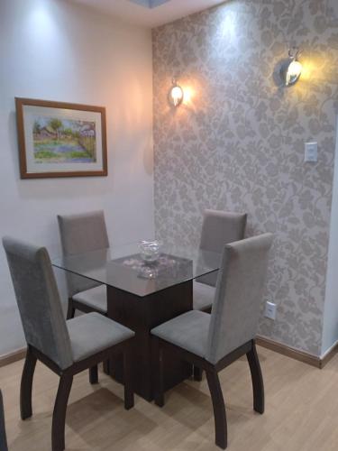 a dining room with a glass table and chairs at Copacabana Beach Modern Apartments in Rio de Janeiro