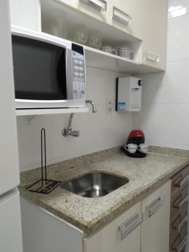 a kitchen with a sink and a microwave at Copacabana Beach Modern Apartments in Rio de Janeiro