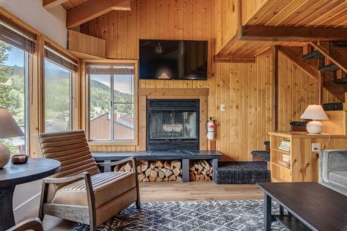 a living room with a fireplace and a tv at Ski Condo in Chalet Village at Brian Head! in Brian Head