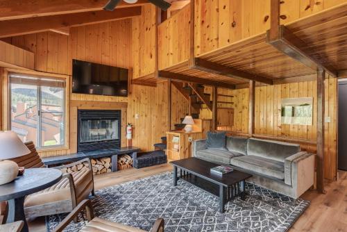 a living room with a couch and a fireplace at Ski Condo in Chalet Village at Brian Head! in Brian Head