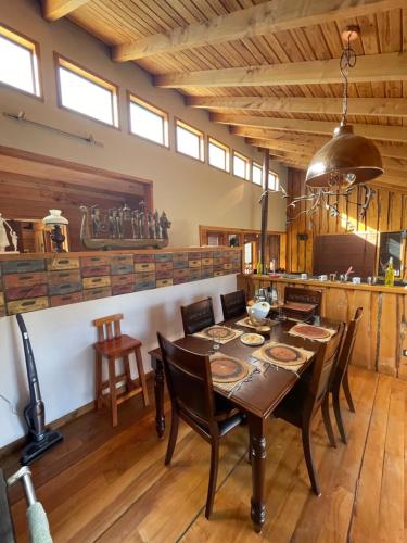 a dining room with a table and chairs at Pucontours River Lodge in Pucón