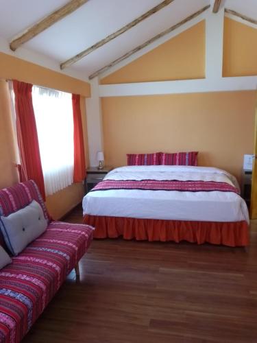 a bedroom with a bed and a couch at "Casa de Valentin" in Llachon