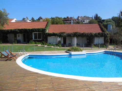 a swimming pool in front of a house at Aguada Chica Bungalows in Villa Carlos Paz