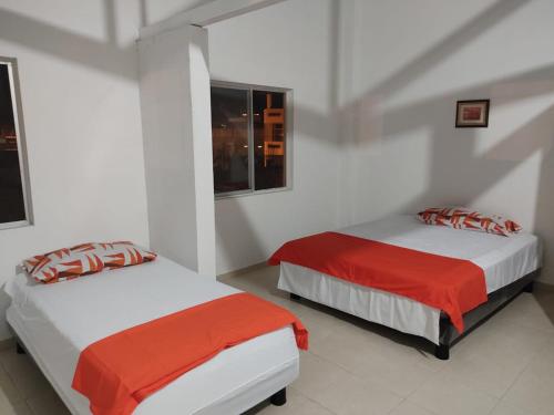 A bed or beds in a room at Olimpia Habitaciones Departamentos