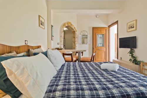 a bedroom with a bed and a dining room at Olive Studios Karpathos Studio #4 in Karpathos