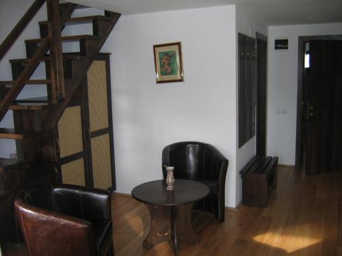 a room with a table and chairs and a staircase at Timis Valley, Casa Eni&Dan in Predeal