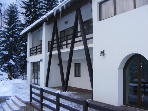 a building with a fence in front of it at Timis Valley, Casa Eni&Dan in Predeal