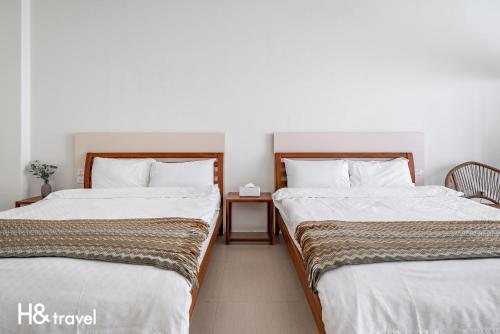 Postel nebo postele na pokoji v ubytování Taitung Rainbow Pet Friendly Maison Resort