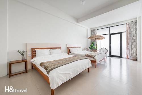 Postel nebo postele na pokoji v ubytování Taitung Rainbow Pet Friendly Maison Resort