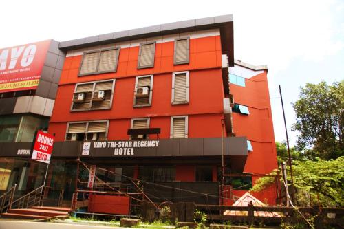 a red building with a sign that reads not the sixth frequency motel at Hotel Tri-Star Regency in Ernakulam