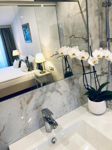 a bathroom with a sink and a mirror at ApartHotel Vila Minka in Ljubljana