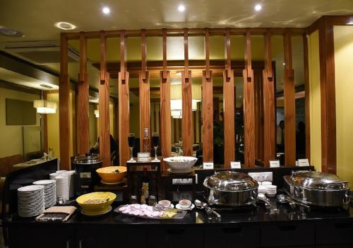a kitchen with pots and pans on a counter at Hotel Green Olive in Aurangabad