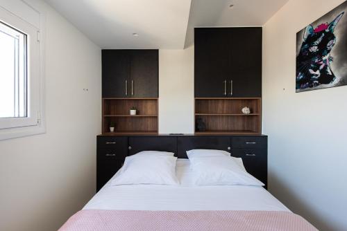 A bed or beds in a room at Analogy chania apartment