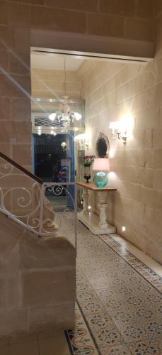 a room with a staircase and a table in a room at Central 214 Boutique Hotel in Hamrun