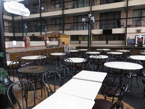 an empty patio with tables and chairs in a building at Clifton Victoria Inn at the Falls in Niagara Falls