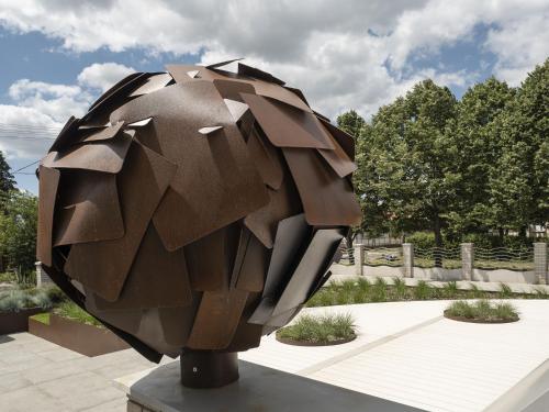 a sculpture of a brown object in a park at Hotel Bestseller in Kecskemét