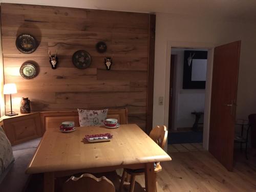 a wooden table in a room with a wooden wall at Ferienhaus Ahornli im Mölltal in Großkirchheim