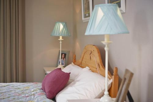 a bedroom with a bed with a lamp and pillows at Cullinan's Guesthouse in Doolin