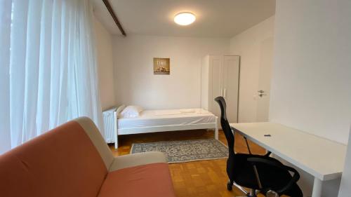 a room with a couch and a desk and a bed at Emona Guesthouse Ljubljana in Ljubljana