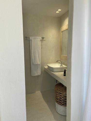 a white bathroom with a sink and a mirror at Raphael Skiathos Living-Olga in Skiathos