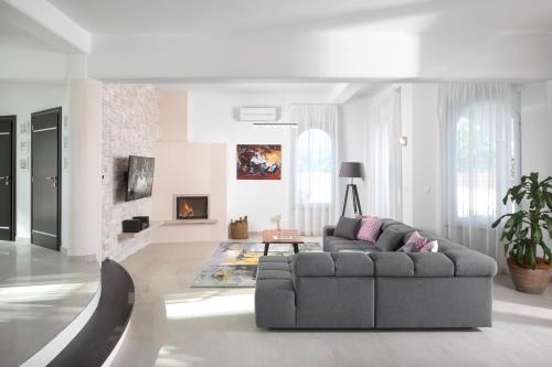 a living room with a couch and a fireplace at Luxury Panorama Vila with amazing Seaview in Gondolici 7 km from Rabac in Labin
