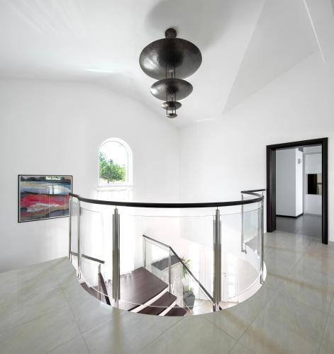 a glass staircase in a white room with a light fixture at Luxury Panorama Vila with amazing Seaview in Gondolici 7 km from Rabac in Labin