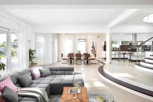 a living room with a couch and a table at Luxury Panorama Vila with amazing Seaview in Gondolici 7 km from Rabac in Labin