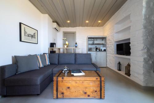 a living room with a couch and a coffee table at Kea Village Suites & Villas in Ioulida