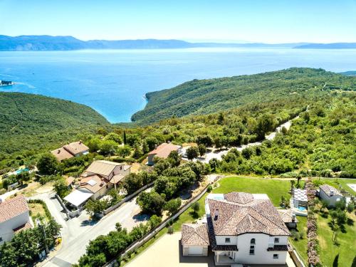 an aerial view of a house and the water at Luxury Panorama Vila with amazing Seaview in Gondolici 7 km from Rabac in Labin