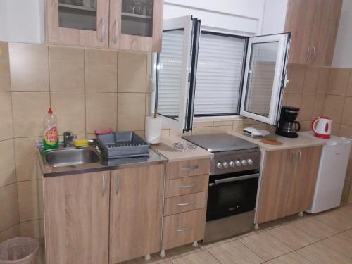a small kitchen with a sink and a stove at Apartments Mirković in Cetinje