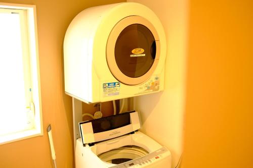 a machine in a bathroom with a toilet at コージーイン 東京桜新町 in Tokyo