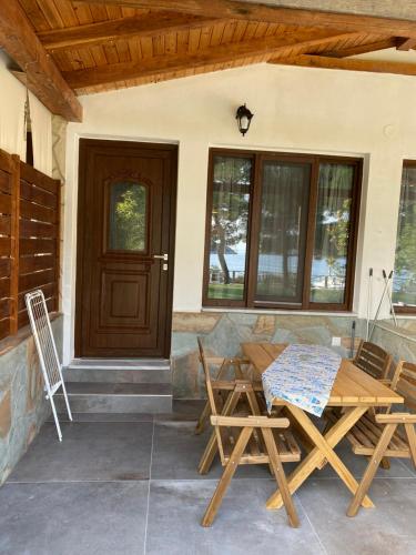 patio con mesa, sillas y puerta en Pinelopi’s House, en Porto Koufo