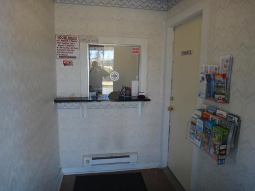 a room with a door with a window and a shelf at Budget Motor Inn- Mahopac in Mahopac