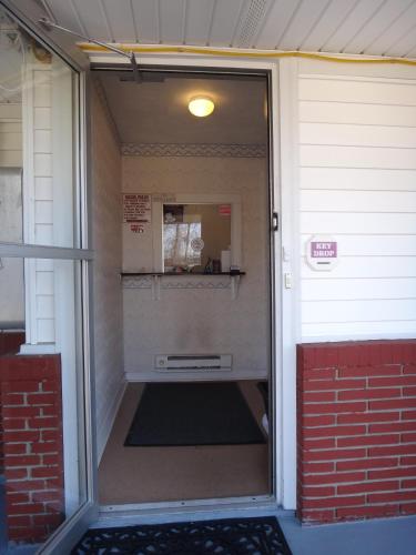an outside door of a building with a door open at Budget Motor Inn- Mahopac in Mahopac