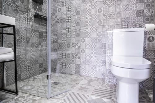 a bathroom with a toilet and a shower at Number 11 by the Warren Collection in Belfast