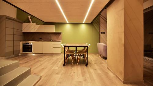 a kitchen with a table in the middle of a room at Il Ronchetto in Cunardo