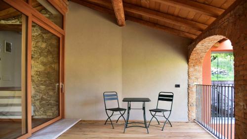 a patio with chairs and a table on a porch at Il Ronchetto in Cunardo