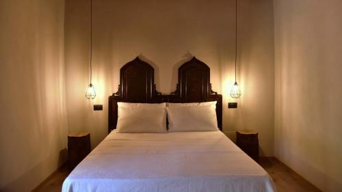 a bedroom with a large bed with two lamps at Il Ronchetto in Cunardo