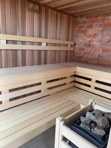 a wooden sauna with a bench in a room at Ferienhaus Jeschkenpanorama in Luftkurort Lückendorf
