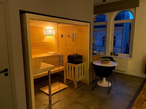 a room with a shower and a table and a chair at Golden Key Apartments in Liberec