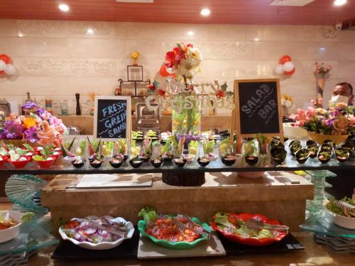a buffet with many different types of food on display at Souvenir Jaipur in Jaipur