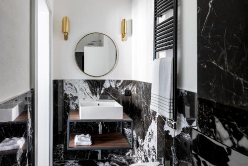 a bathroom with a sink and a mirror at 4F Boutique Hotel Florence in Florence