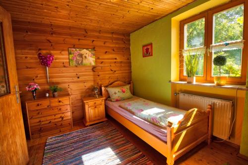 a bedroom with a bed in a wooden room at Feriensuite-auf-dem-Bauernhof-fuer-2-3-Personen-im-Herzen-Niederbayerns in Mamming