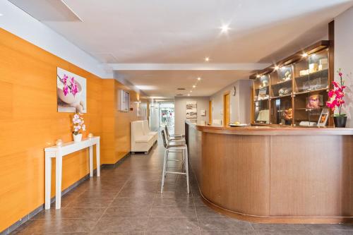 a bar in a room with a counter at Hotel Balneario Playa de Comarruga in Comarruga