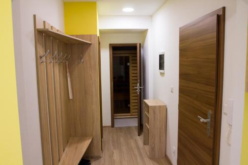 a hallway with a closet and a door at Apartmány Valča in Valča