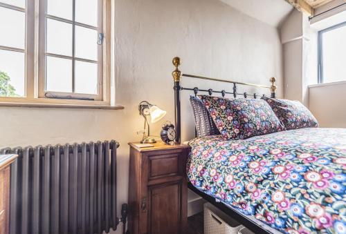 a bedroom with a bed and a radiator at Loaf in Bridport